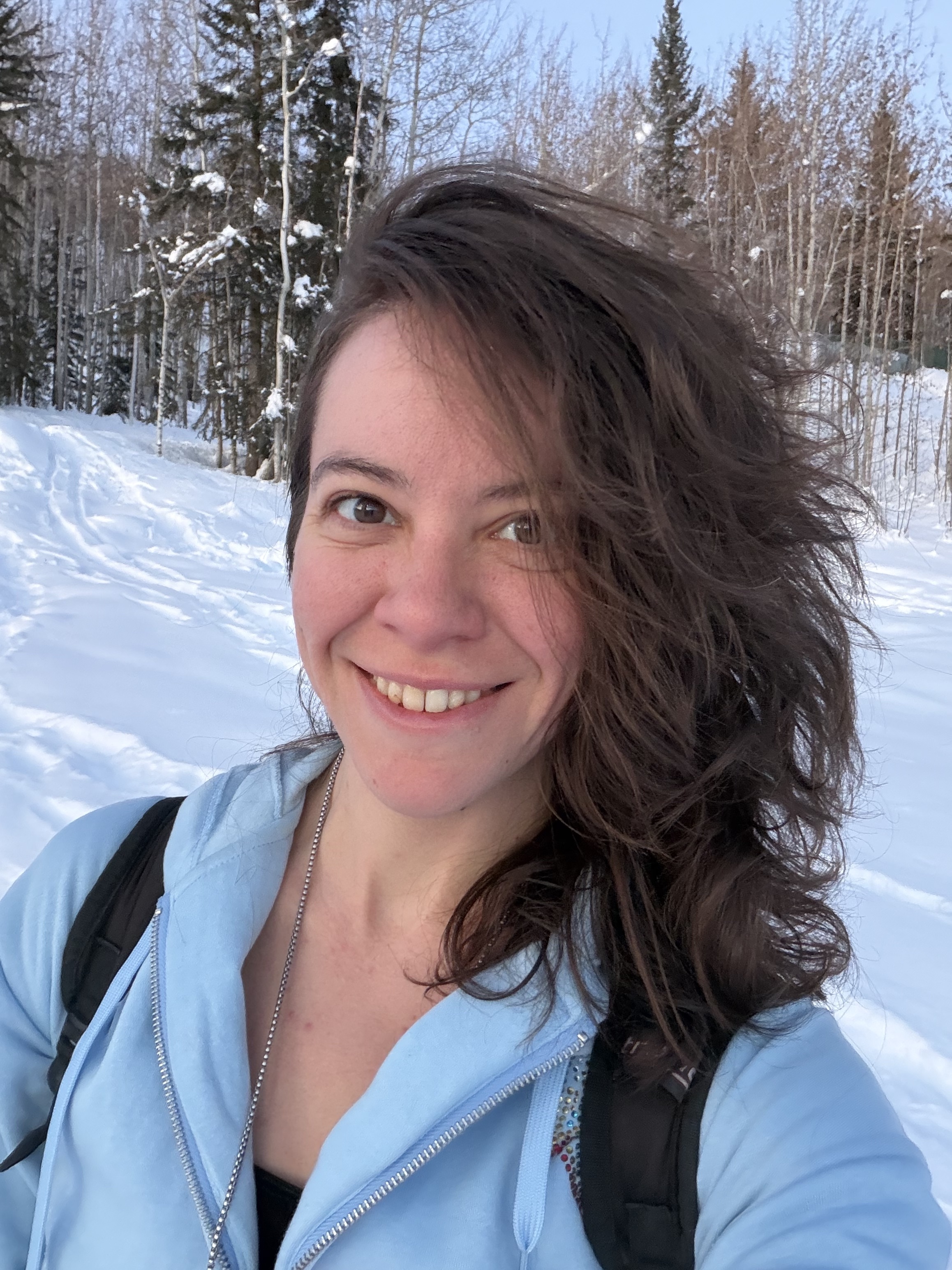 A person similing in front of snow